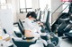 A woman sitting on a stationary bike in a gym.