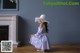 A little girl sitting on the floor in front of a fireplace.