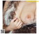 A close up of a woman's breasts in a fur coat.